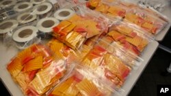 Confiscated synthetic drugs are on display at a news conference at the DEA offices in Centennial, Colo., on Wednesday, May 7, 2014.