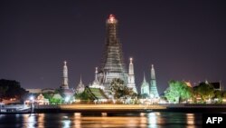 FILE - The main structure at the Wat Arun temple in Bangkok stands with its lights switched on in Bangkok, March 25, 2017.