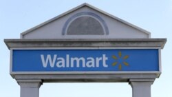 A Walmart logo forms part of a sign outside a Walmart store, Tuesday, Sept. 3, 2019, in Walpole, Mass.