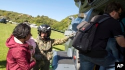 In this image provided by the Royal New Zealand Defense Force, tourists are evacuated by helicopter from Kaikoura following Monday's earthquake, in New Zealand, Nov. 15, 2016.