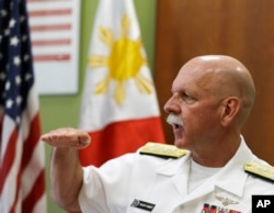FILE - U.S. Pacific Fleet Commander Adm. Scott Swift gestures during an interview with journalists July 17, 2015 in Manila, Philippines.