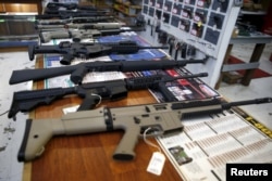 FILE - Guns for sale are displayed in the Roseburg Gun Shop in Roseburg, Oregon, a day after nine people were killed in a mass shooting in Roseburg, Oct. 2, 2015.