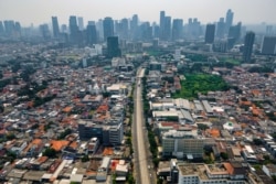 FILE - This aerial photo shows a road leading to Jakarta city center.