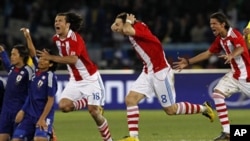 Paraguay's Nelson Haedo Valdez, foreground left, Paraguay's Edgar Barreto, center foreground, and Paraguay's Enrique Vera, right, celebrate after winning the penalty shootouts during the World Cup round of 16 soccer match between Paraguay and Japan at the