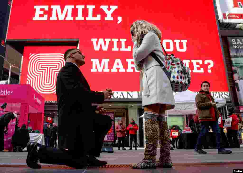 Joe lodato proposes to Emily Gambarella on Valentine&#39;s Day in Times Square in New York, Feb. 14, 2018.