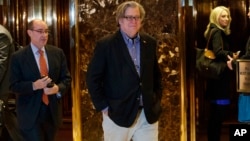 FILE - Stephen Bannon, campaign CEO for President-elect Donald Trump, leaves Trump Tower in New York, Nov. 11, 2016. On Saturday, protesters in Washington, D.C., rallied against Trump's election and choice of advisers.