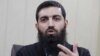 FILE- Halis Bayancuk, a Turkish cleric detained several times on suspicion of aiding al-Qaida, in Istanbul, Turkey, March 22, 2015. Bayancuk, 31, also known as Abu Hanzala, has cautioned Ankara against taking a more active role in the U.S.-led fight again