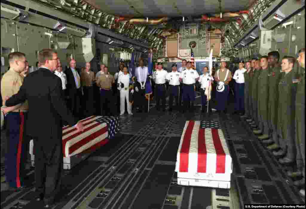 U.S. Defense Secretary Ash Carter, second left, with U.S. military members after they loaded the casket of what could be the remains of one to two crew members from a World War Two crash, in a C-17 aircraft, at Palam airport, in New Delhi, India, April 13