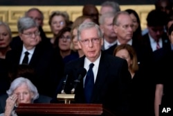 Senate Majority Leader Mitch McConnell of Kentucky speaks during a ceremony for Sen. John McCain as he lies in state in the Rotunda of the U.S. Capitol, Aug. 31, 2018, in Washington. McCain's 106-year-old mother, Roberta McCain, is seen bottom left.