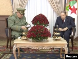 Algeria's President Abdelaziz Bouteflika meets with Army Chief of Staff Lieutenant General Ahmed Gaid Salah in Algiers, Algeria, in this handout still image taken from a TV footage released on March 11, 2019.