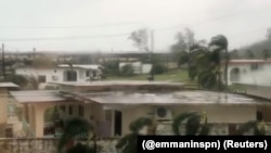 Trees sway during a storm as Super Typhoon Yutu descends upon Saipan, Northern Mariana Islands, Oct. 25, 2018, in this image taken from a video obtained from social media.