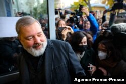 FILE - Russia's top independent newspaper Novaya Gazeta chief editor Dmitry Muratov meets with reporters outside the newspaper's office, in Moscow, Oct. 8, 2021.