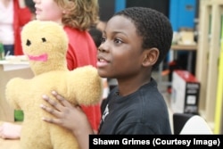 Jacob Leggette shows off his "Tender Hugs" Bear that he made with help from a 3-D printer. (Courtesy: Digital Harbor Foundation)