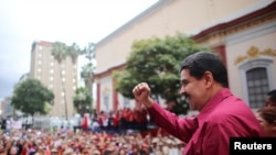 Venezuela's President Nicolas Maduro gestures as he arrives for a rally with supporters in Caracas, Nov. 7, 2017. 