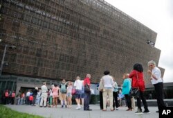 FILE - People wait in line to enter the Smithsonian National Museum of African American History and Cultural on the National Mall in Washington, May 1, 2017. On Thursday, a second noose, a symbol of racism in the U.S., was found on Smithsonian grounds.