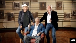 Bobby Bare, left, Jack Clement, center, and Kenny Rogers, right, pose for photographers in the Country Music Hall of Fame in Nashville, Tennessee, April 10, 2013.