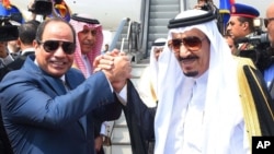 FILE - Egyptian President Abdel-Fattah el-Sissi, left, shakes hands with Saudi Arabia's King Salman before he departs Egypt, April 11, 2016. The transfer of Tiran and Sanfir was included in April in a maritime border agreement with Saudi Arabia.