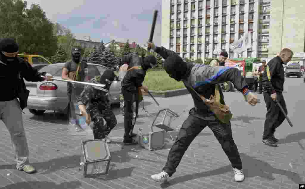 Pro-Russian militants smash ballot boxes in front of the seized regional administration building in Donetsk. Ukraine&#39;s critical presidential election got underway under the wary scrutiny of a world eager for stability in a country rocked by a deadly uprising in the east.