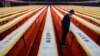 FILE - A visitor looks at a part of a Chinese calligraphy of Buddhist scriptures done by artist He Guojian on display at a stadium in Shenzhen, Guangdong province.