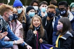 Swedish climate activist Greta Thunberg, centre, speaks alongside fellow climate activists during a demonstration at Festival Park, in Glasgow, Scotland, on the first day of the COP26 summit, Nov. 1, 2021.