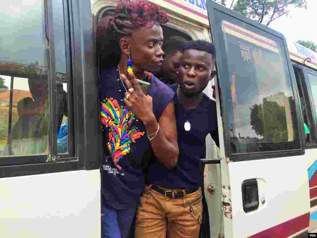 After stopping on the side of the road, LGBT Ugandans emerged from the buses demanding answers from the police. (L. Paulat/VOA) 