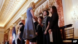 Ivanka Trump shakes hands with people honored for their work to stop human trafficking including Allison Lee, of Taiwan, and Boom Mosby, of Thailand, right, during a 2017 Trafficking in Persons Report ceremony at the State Department, June 27, 2017, in Washington.