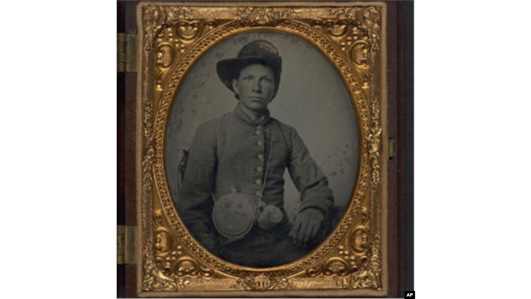 Unidentified young soldier in Confederate shell jacket, Hardee hat with Mounted Rifles insignia between 1861 and 1865.
