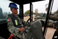 A Mexican army soldier drives a motor grader during the launch of the construction of Mexico City's new airport at the Military Airbase Number 1 in Santa Lucia, on the outskirts of Mexico City, April 29, 2019.