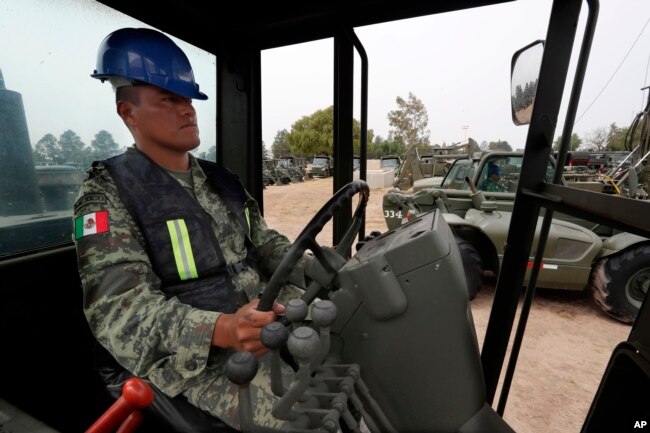 A Mexican army soldier drives a motor grader during the launch of the construction of Mexico City's new airport at the Military Airbase Number 1 in Santa Lucia, on the outskirts of Mexico City, April 29, 2019.