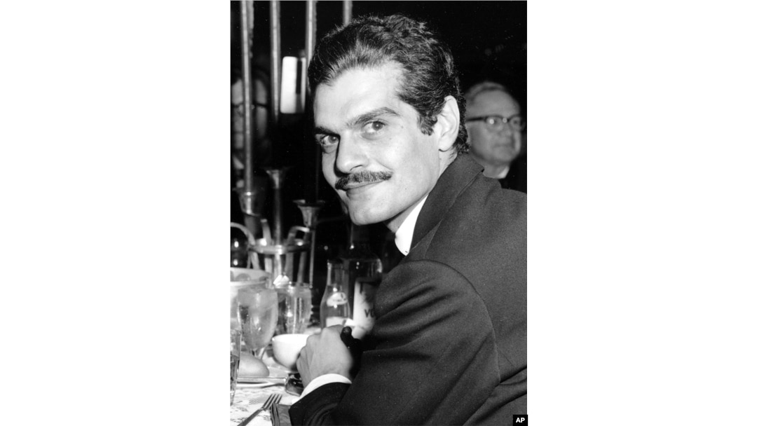 FILE - Actor Omar Sharif poses for a photo at a dinner party following the movie premiere of "Lawrence of Arabia" in Hollywood, California, Dec. 21, 1962.