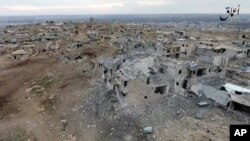This image taken from drone footage posted online Jan. 2, 2017, by the Aamaq News Agency, a media arm of the Islamic State group, purports to show an aerial image of a neighborhood damaged by Turkish airstrikes in the northern Syrian town of al-Bab.
