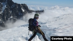 Mountaineer Stephanie Groen stands by a deep crevasse on a glacier in New Zealand, where she worries about signs of rapid ice-melt. (Courtesy: Stephanie Groen)