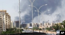 In this image made from video by The Associated Press, smoke rises from the direction of Tripoli airport in Tripoli, Libya, July 13, 2014.