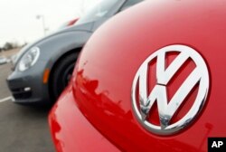 FILE - The Volkswagen logo on the hood of a 2012 Beetle at a Volkswagen dealership.