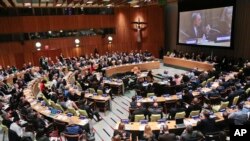 A large video monitor shows former New York mayor Michael Bloomberg, the U.N. Secretary-General’s special envoy for cities and climate change, address the biennial Investor Summit on Climate Risk on Jan. 27, 2016, at U.N. headquarters.