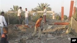 Palestinians inspect the damage to a building following an Israeli airstrike in Deir el-Balah, central Gaza Strip, 19 Nov 2010