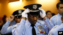  An LAPD Cadet Commander adjusts his hat before the LAPD Cadet Program Graduation of the cadet "Class of 7-2014".