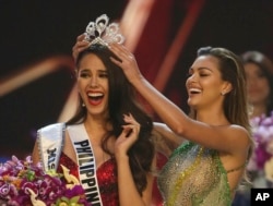 Catriona Gray of the Philippines, left, reacts as she is crowned the new Miss Universe 2018 by Miss Universe 2017 Demi-Leigh Nel-Peters during the Miss Universe competition in Bangkok, Thailand, Monday, Dec. 17, 2018.