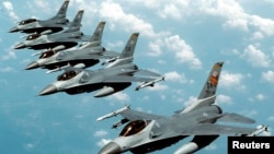 FILE- Five U.S. Air Force F-16 "Fighting Falcon" jets fly in echelon formation over the U.S. en route to an exercise in this undated file photograph. 