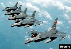 FILE- Five U.S. Air Force F-16 "Fighting Falcon" jets fly in echelon formation over the U.S. en route to an exercise in this undated photograph.
