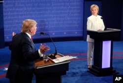 Democratic presidential nominee Hillary Clinton and Republican presidential nominee Donald Trump debate during the third presidential debate at UNLV in Las Vegas, Oct. 19, 2016.