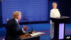 FILE - Democratic presidential nominee Hillary Clinton and Republican presidential nominee Donald Trump debate during the third presidential debate at UNLV in Las Vegas, Oct. 19, 2016.