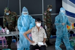 FILE - A man receives a dose of the Sinovac vaccine from China against the Covid-19 coronavirus at the Australian Centre for Education in Phnom Penh on May 1, 2021, as part of the government's campaign to halt the rising number of cases of the virus. (AFP)