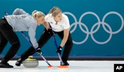 Britain's Anna Sloan, left, sweeps ice with her teammate during their women's curling match against Denmark at the 2018 Winter Olympics in Gangneung, South Korea, Feb. 17, 2018.