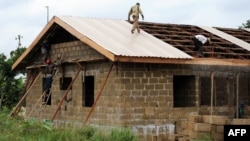 Workers roof building at the new Bakassi Town, which is being developed to relocate displaced citizens, Cross River State, Bakassi Peninsula, Aug. 2008 file photo.