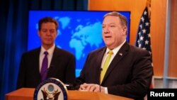 U.S. Secretary of State Mike Pompeo (R) and Ambassador-at-Large for International Religious Freedom Sam Brownback release and the department's annual report on religious freedom around the world, in Washington, May 29, 2018.