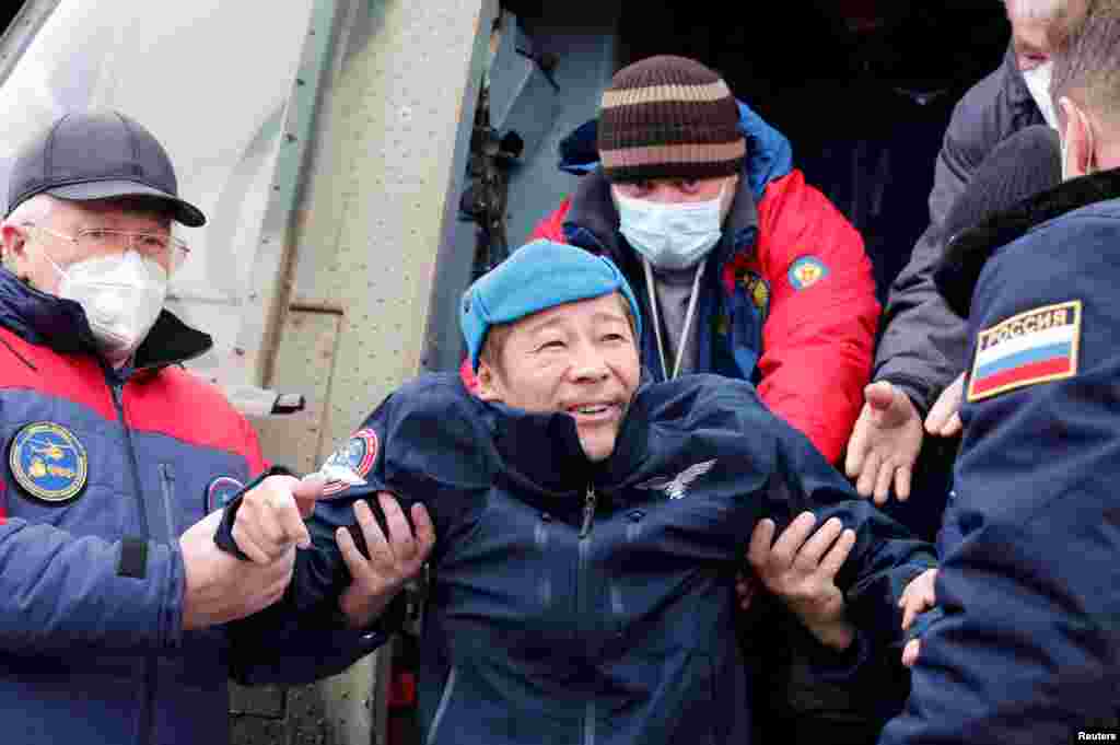 Space flight participant Japanese entrepreneur Yusaku Maezawa disembarks from a helicopter as he arrives at Zhezkazgan airport after returning from the International Space Station on the Soyuz MS-20 space capsule, in Zhezkazgan, Kazakhstan.