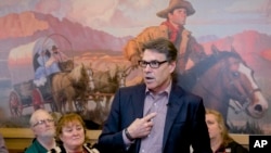In this May 18, 2015 photo, former Texas Gov. Rick Perry addresses voters during a meet and greet event at Pizza Ranch in Sioux Center, Iowa.