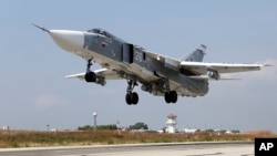 FILE - A Russian SU-24M jet fighter takes off from an airbase in Syria, Oct. 6, 2015.
