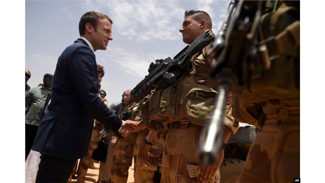 FILE - French President Emmanuel Macron, visits soldiers of Operation Barkhane, France’s largest overseas military operation, in Gao, Northern Mali, May 19, 2017.